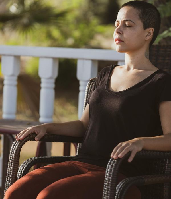 Person practicing mindful breathing in cyberpunk meditation space